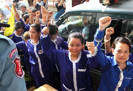 Anti-eviction protesters from the Boeng Kak community raise their arms in defiance upon arriving at the Appeal Court in June. Though their conviction for protesting was upheld, the court ordered them released from prison on the grounds they were 'women, poorly educated and they have children.' (Siv Channa)