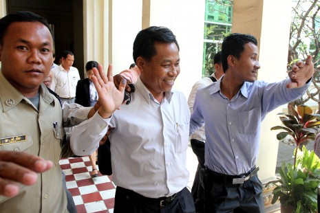 Former Bavet City governor Chhouk Bundith, center, leaves the Appeal Court in Phnom Penh on Wednesday following a hearing on his alleged role in the shooting of three women during a violent strike in Svay Rieng province last year. (Siv Channa)