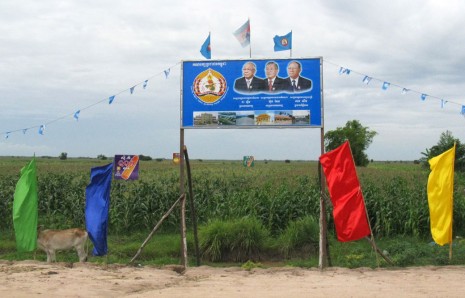 A CPP campaign sign stands along a dirt road running through corn plantations in rural Prey Veng province. (Colin Meyn/The Cambodia Daily)