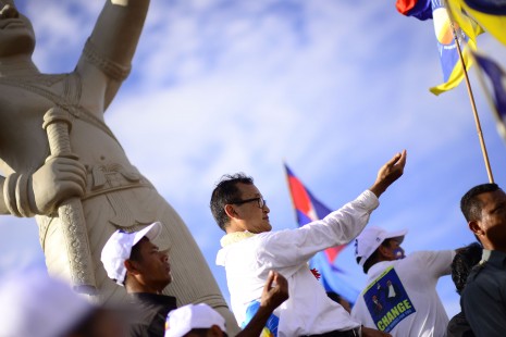 Cambodia National Rescue Party president Sam Rainsy addresses several thousand supporters atop a statue in Prey Veng City on Thursday, where he was rallying support on the penultimate day of the official election campaign period. (Lauren Crothers/The Cambodia Daily)