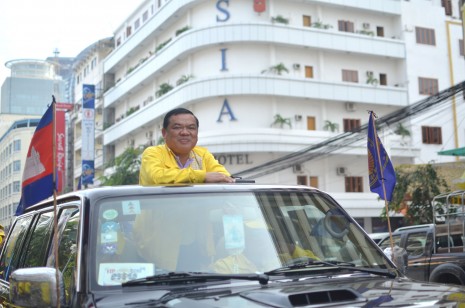 Funcinpec Secretary-General Nhiek Bun Chhay travels Wednesday through Phnom Penh as the party paraded through the capital ahead of the national election on July 28. Mr. Bun Chhay led Funcinpec's forces in 1997 as the party's first deputy RCAF chief of staff when intense fighting between troops loyal to then-First Prime Minister Norodom Ranariddh and then-Second Prime Minister Hun Sen broke out in the capital. (Simon Marks/The Cambodia Daily)