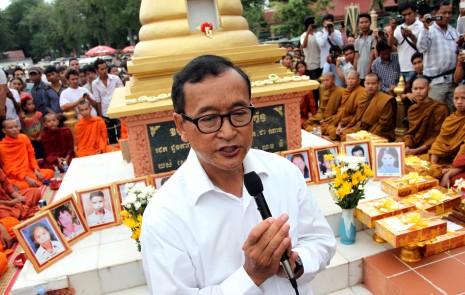 Opposition leader Sam Rainsy addresses supporters Tuesday at a stupa in Phnom Penh memorializing the victims of a grenade attack on an opposition rally in 1997. (Siv Channa)