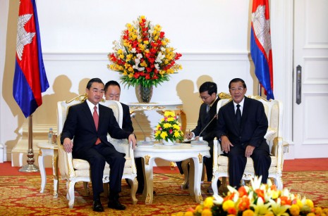 Prime Minister Hun Sen, right, meets with Chinese Foreign Minister Wang Yi at Mr. Hun Sen's office building in Phnom Penh on Wednesday, where Mr. Wang congratulated the ruling CPP on winning last month's national election. (Reuters)