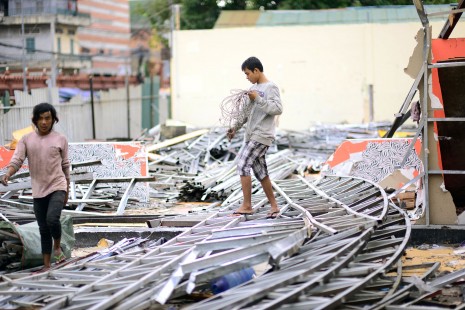Workers dismantle a strip of restaurants on Street 13 behind Phnom Penh's Wat Ounalom on Wednesday. Dozens of businesses and renters have received orders to leave the area from the powerful Sokimex Group, a local conglomerate. (Lauren Crothers/The Cambodia Daily)