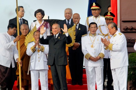 King Norodom Sihamoni emerges from Independence Monument in Phnom Penh after setting the victory torch alight to mark 60 years of independence from France on Saturday morning. King Sihamoni is flanked by Prime Minister Hun Sen on his left and National Assembly President Heng Samrin. (Siv Channa)