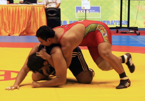 Cambodian gold medal winner Dorn Sov, top, grapples with Phyo Zaw Khaing of Burma in the 120 kg Men's Freestyle Wrestling final at the 27th Southeast Asia Games in Naypyidaw on Thursday. (Nguon Makara/Wrestling Federation of Cambodia)