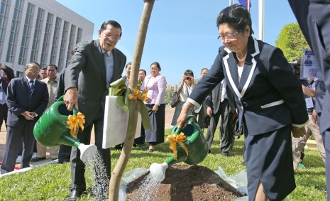 Prime Minister Hun Sen and Gu Xiulian, visiting president of the China-Cambodia Friendship Association, water a tree sapling, which they planted at Mr. Hun Sen's Peace Palace in Phnom Penh on Wednesday to mark the 55th anniversary of relations between the two countries. (Siv Channa)