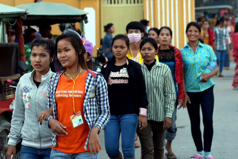 Garment workers leave factories along Veng Sreng Street in Phnom Penh on Monday as unions began the first phase of nationwide strikes by calling on workers to boycott working overtime. (Siv Channa)