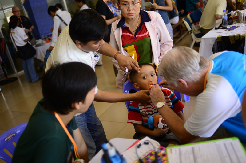 A young boy is examined during the first day of screening for cases of cleft lip and palate by the NGO Operation Smile at the Khmer-Soviet Friendship Hospital in Phnom Penh on Sunday. (Lauren Crothers/The Cambodia Daily)