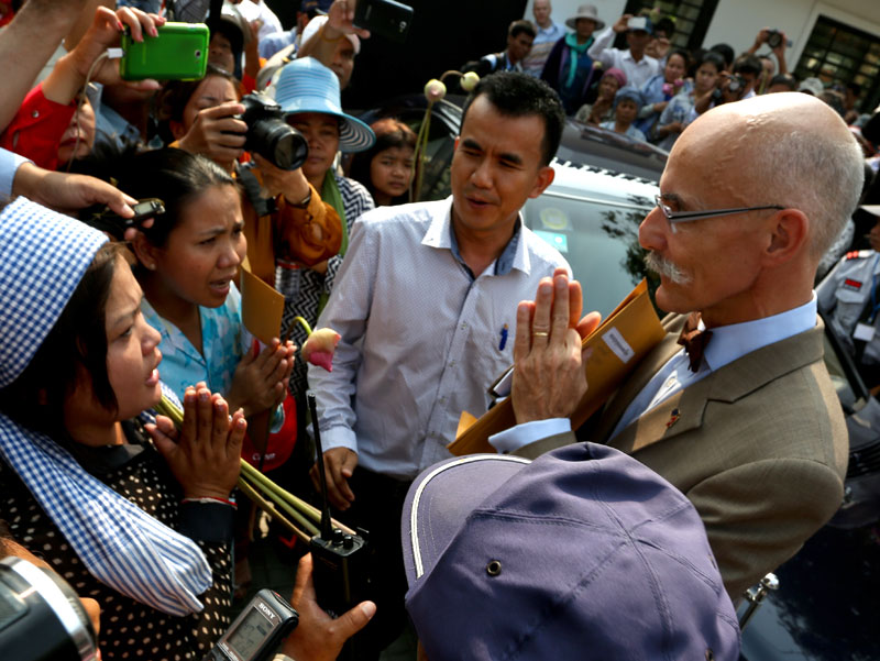 E.U. Ambassador Jean-Francois Cautain greets anti-eviction activists from the Borei Keila community outside the E.U. Embassy in Phnom Penh on Thursday. (Siv Channa)
