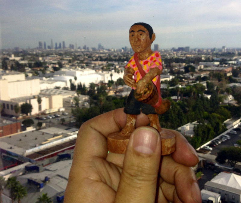 Filmmaker Rithy Panh holds up a clay figurine of his younger self in front of the Los Angeles skyline in a photo posted to his Twitter feed on Thursday.