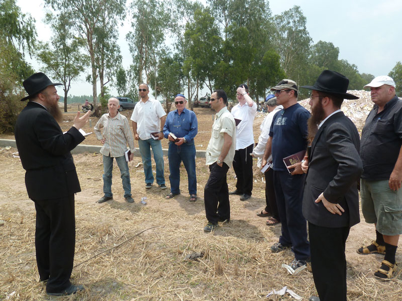 Chief Rabbi of Thailand Joseph Kantor, left, Cambodia's Rabbi Bentzion Butman, right, and members of Phnom Penh's Jewish community take part in the funeral of 56-year-old Israeli man Shekalim Mukerjee on Friday at the new Jewish Cemetery in Kandal province. (Chabad Jewish Center of Cambodia)