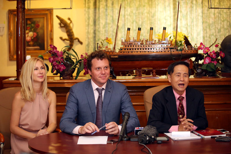 Sergei Polonsky, center, his wife Olga Deripasko and his lawyer Benson Samay speak with the press Friday following the Supreme Court’s announcement that Mr. Polonsky would not be extradited to Russia. (Siv Channa)