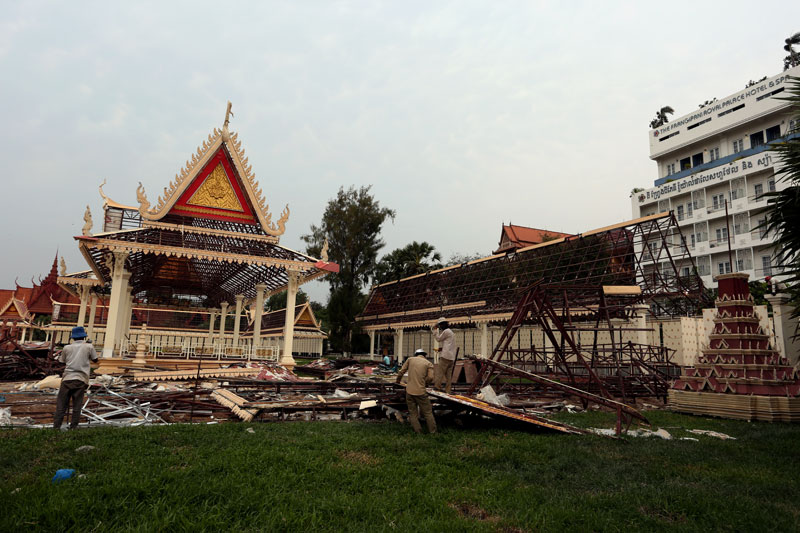 Workers dismantle decorative pavilions erected for the February 2013 funeral of the late King Father Norodom Sihanouk at Phnom Penh's Veal Mean park Tuesday. (Siv Channa)