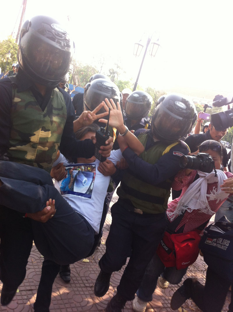 Security Guards Assault CNRP Supporters at Freedom Park 2 CNRP lawmaker-elect Mu Sochua is carried out of Freedom Park by Daun Penh district security guards Monday morning. (Kevin Doyle)