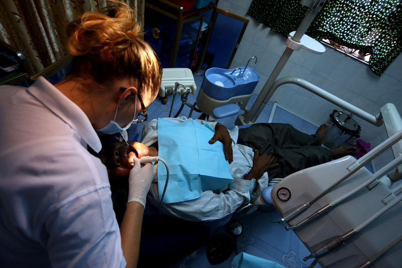 Dentist Evelin Hoedemaker extracts a man’s decayed tooth at the CHOICE clinic. (Siv Channa)