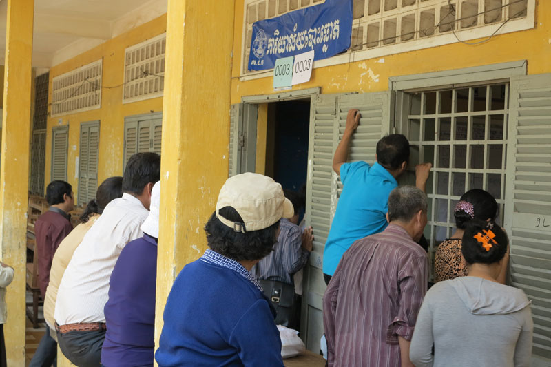 Commune councilors in Phnom Penh's Prampi Makara district wait to vote in council elections on Sunday. (San Sinary/The Cambodia Daily)