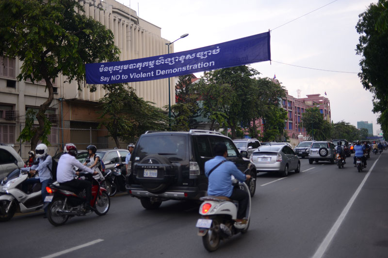 A banner is strung across Norodom Boulevard in central Phnom Penh on Wednesday ahead of International Workers' Day on Thursday. (Lauren Crothers/The Cambodia Daily)