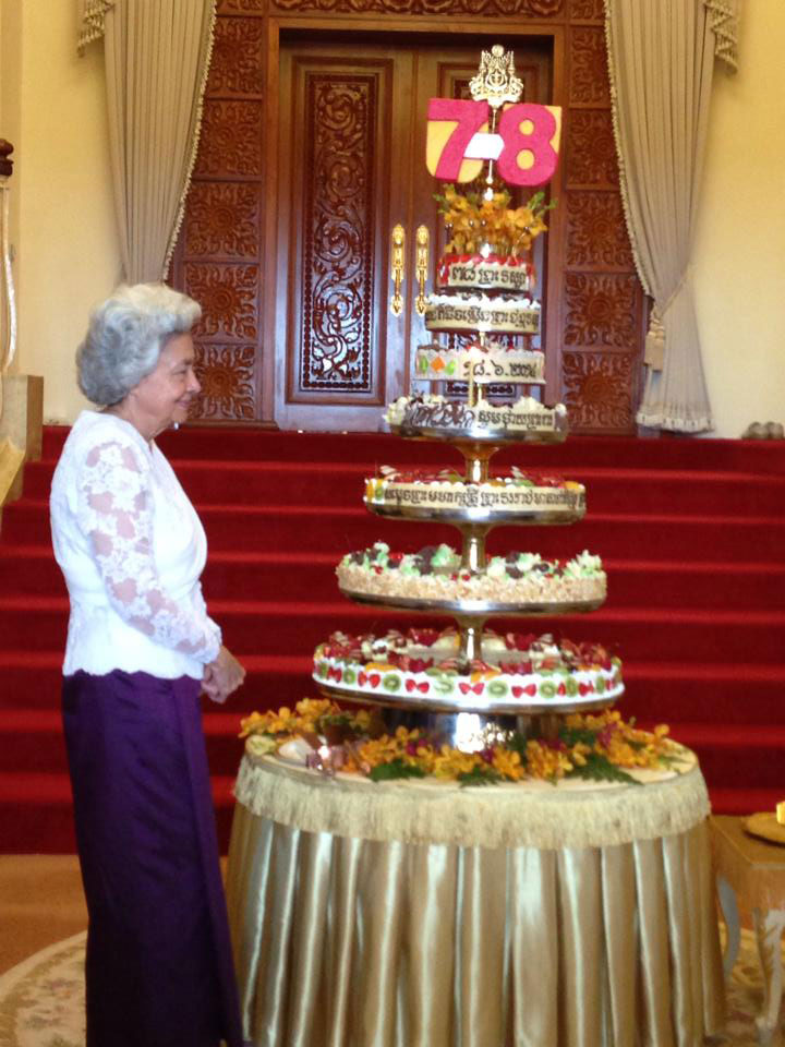 Queen Mother Norodom Monineath inspects a seven-tier cake made in honor of her 78th birthday on Wednesday in a photograph posted to the Facebook page of Princess Norodom Arunrasmey.