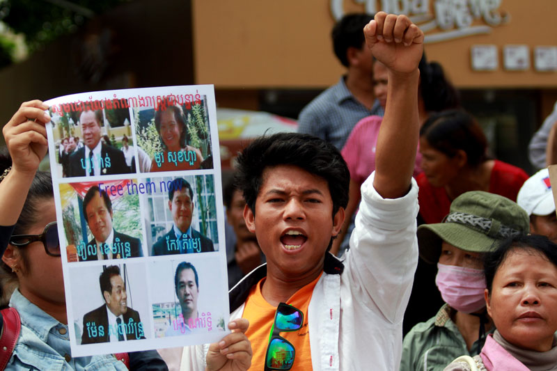 Parties Offer Conflicting Narratives of Protest Clash 1 Opposition supporters on Friday chant for the release of eight CNRP officials, including seven lawmakers-elect, who are being held in pre-trial detention at Prey Sar prison on charges of insurrection and incitement to commit a felony. (Siv Channa/The Cambodia Daily)
