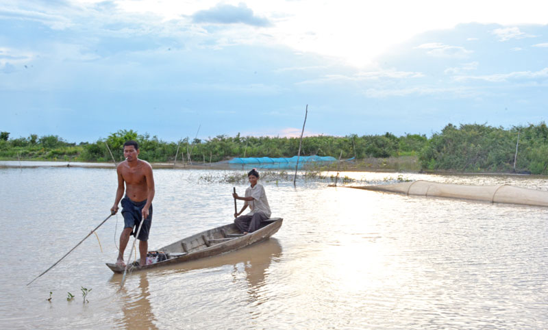 Khan Thea and his wife, Chab Chroeb, use their electro-fishing gear in Be Prammuoy Lake last week. (Alex Consiglio/The Cambodia Daily)