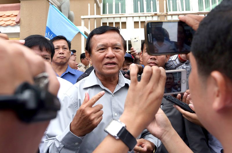 CNRP Vice President Kem Sokha speaks to reporters Friday after being questioned in court. (Siv Channa/The Cambodia Daily)