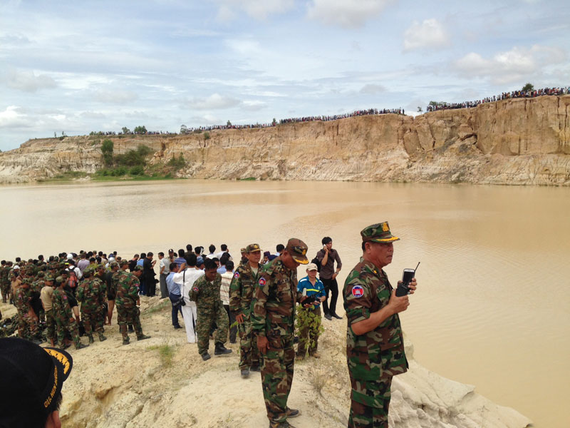 Royal Cambodian Armed Forces personnel coordinate recovery efforts Monday after a Chinese-built military helicopter crashed in Phnom Penh’s Dangkao district, killing an air force deputy commander and at least three other soldiers. (Siv Channa/The Cambodia Daily)