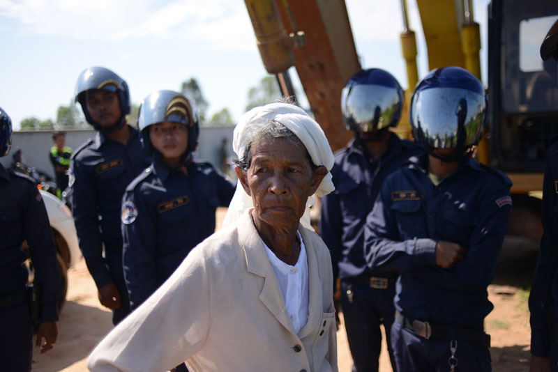 Huot Sarom, 68, takes a break on Thursday between scuffles with security guards in her bid to hold onto 5.67 hectares of land in Phnom Penh's Pur Senchey district, which she says she has farmed since 1979. Ms Sarom has been feuding over the plot with 120 families who sold it to a cousin of the prime minister. (Lauren Crothers/The Cambodia Daily)