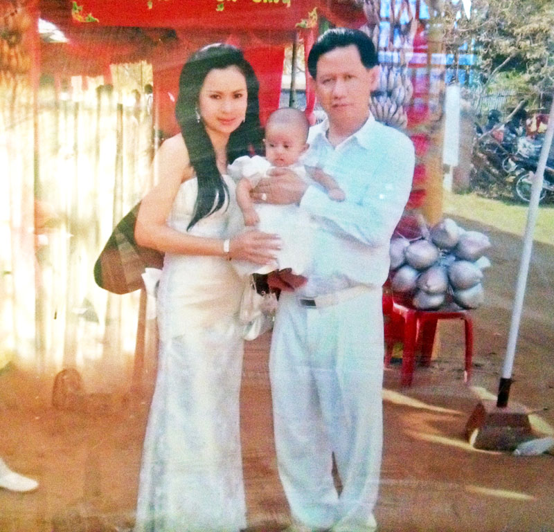 Va Dary, 30, and her husband Major General Kim Marintha pose for a photograph with their daughter Kim Thavichada at the wedding of her older brother in Kompong Cham province in 2009. (Courtesy of Mey Lyly)