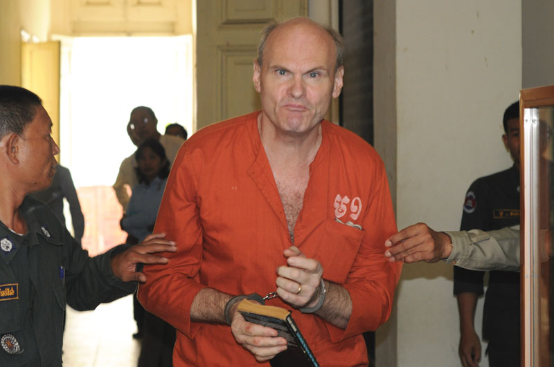 Convicted British pedophile Michael Leach, 54, reacts angrily to reporters prior to his hearing at the Appeal Court on Thursday. (Simon Henderson/The Cambodia Daily)
