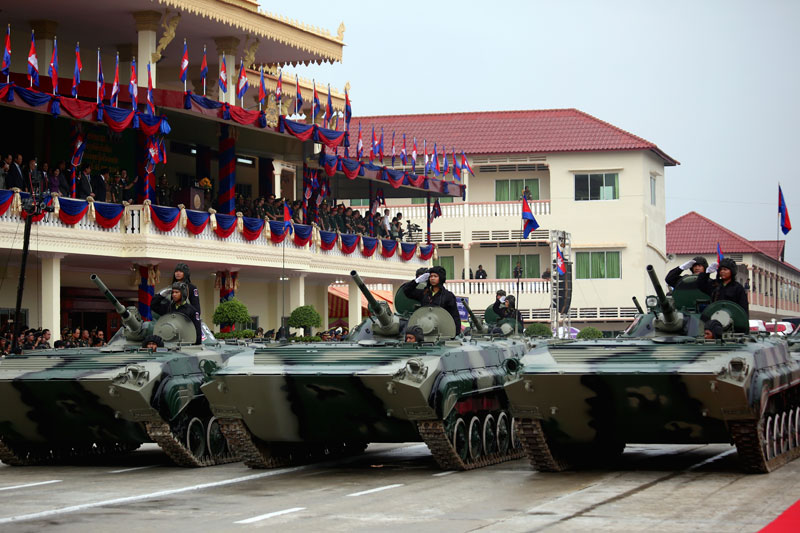 Tanks roll past a delegation of military officials at the Royal Cambodian Armed Forces Brigade 70 headquarters in Phnom Penh's Pur Senchey district on Monday. Prime Minister Hun Sen presided over a ceremony to mark the 20th anniversary of the elite military unit. (Siv Channa/The Cambodia Daily)