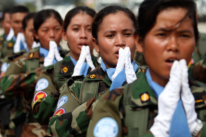 Peacekeepers from the Royal Cambodian Armed Forces' Engineering Company 945 place their hands together in a traditional 'sampeah' during a ceremony Wednesday at the Phnom Penh Military Airbase ahead of a one-year mission to the Central African Republic. (Siv Channa/The Cambodia Daily)