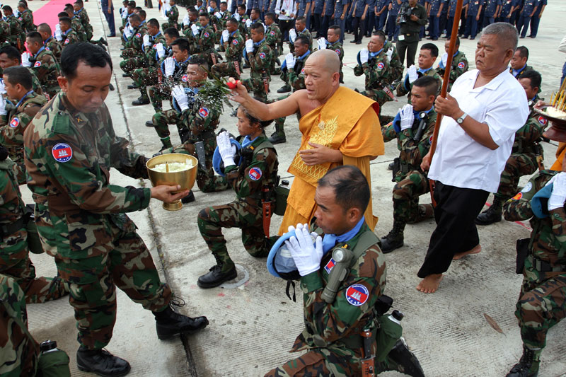 A monk blesses peacekeepers at the Phnom Penh Military Airbase on Wednesday. (Siv Channa/The Cambodia Daily)