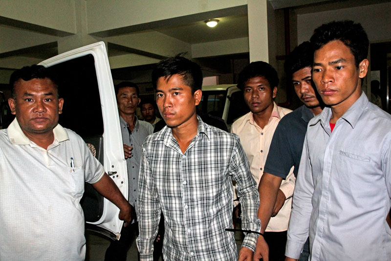 Members of the Khmer National Liberation Front, who were arrested this week, leave Phnom Penh Municipal Court on Friday after being questioned for allegedly plotting to incite violence. (Siv Channa/The Cambodia Daily)