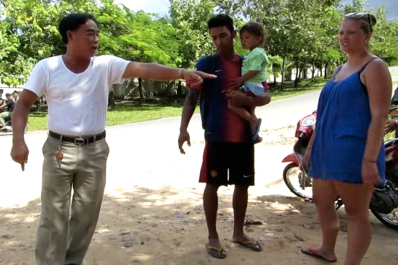 Police official Pheak Phearum, left, stands next to Lisa-Marie Nass-Starr, her boyfriend, Nhoeng Buntheuy, and their son after their altercation in Sihanoukville on Tuesday. (Chum Phearum)