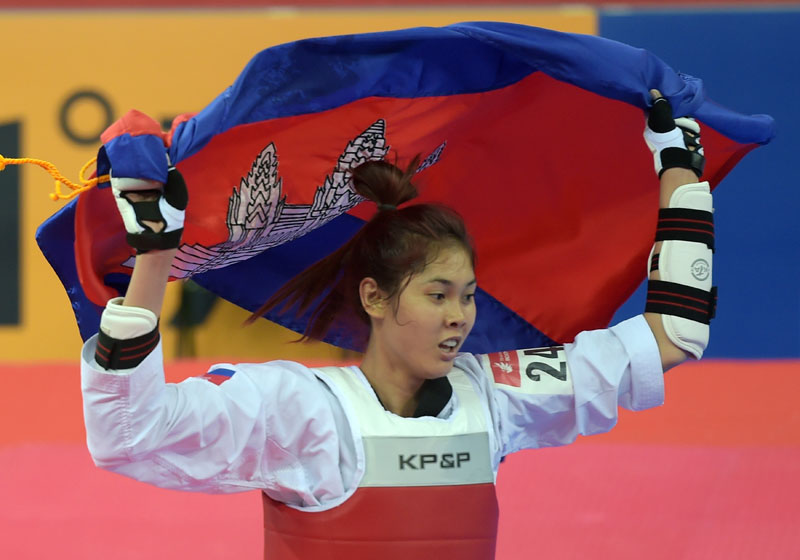 Sorn Seavmey celebrates on Friday after defeating Iran's Fatemeh Rouhani in the final of the women's under-73 kg taekwondo competition at the 17th Asian Games in Incheon, South Korea. The victory marked Cambodia's first gold medal at the games. (AFP)