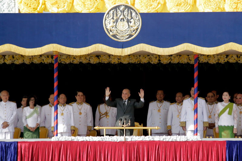 King Norodom Sihamoni waves from a platform in front of the Royal Palace in Phnom Penh on Wednesday during a ceremony to mark 10 years since his coronation. (Siv Channa/The Cambodia Daily)
