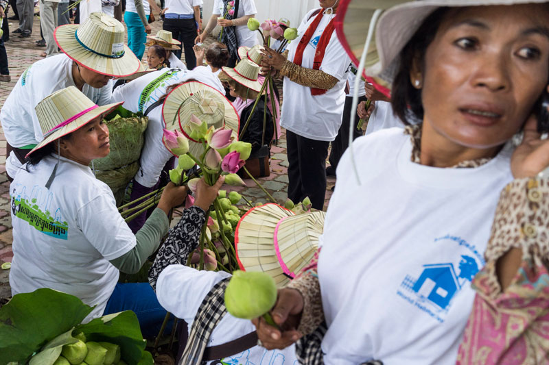 Protesters distribute lotus flowers in Phnom Penh on Monday ahead of a demonstration to mark World Habitat Day. About 1,500 protesters marched to the National Assembly, where they delivered a petition calling on the government to end forced evictions and compensate those already affected by them. (John Vink)