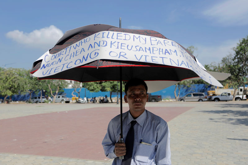 Roeurn Kosal stands in Freedom Park in Phnom Penh on Monday during his one-man protest against the guilty verdict handed down in August by the Extraordinary Chambers in the Courts of Cambodia against Khmer Rouge leaders Nuon Chea and Khieu Samphan. (Siv Channa/The Cambodia Daily)