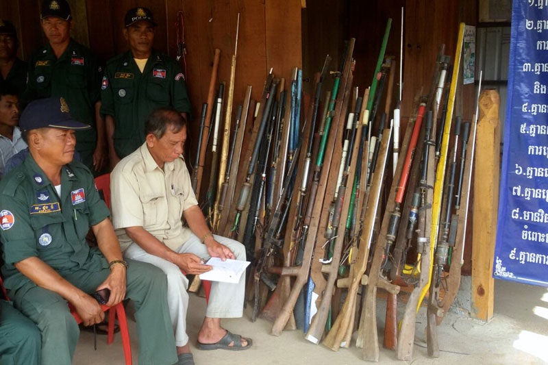 Villagers, police and local officials attend a safety lecture in Kompong Chhnang province's Samaki Meanchey district on Tuesday, after 35 homemade air rifles were turned in to provincial police. (Keo Chhun)