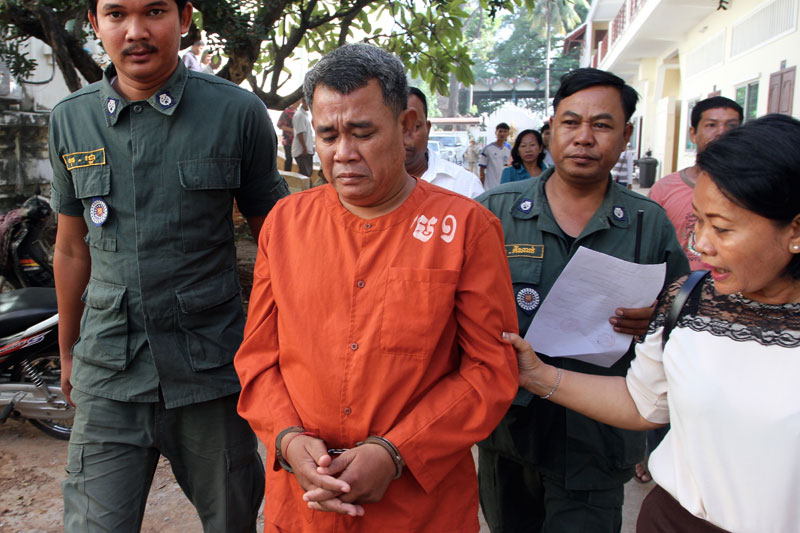 Chbar Ampov district councilor Soum Vuthy, a member of the opposition CNRP, is escorted by police at the Appeal Court in Phnom Penh on Wednesday following his failed bid to secure bail. (Siv Channa/The Cambodia Daily)