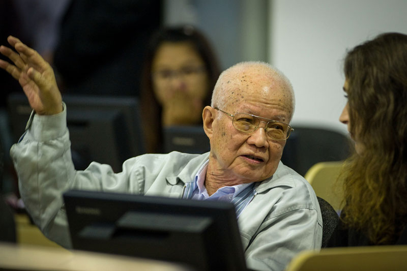 Former Khmer Rouge leader Khieu Samphan confers with a member of his defense team at the Khmer Rouge Tribunal during the opening of Case 002/02 last month. (Extraordinary Chambers in the Courts of Cambodia)