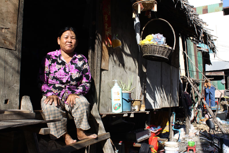 Whelk seller Kai Kimsrin sits on the top step of the rental shack she shares with her husband and five children in Phnom Penh's Chamkar Mon district on Thursday. (Holly Robertson/The Cambodia Daily)