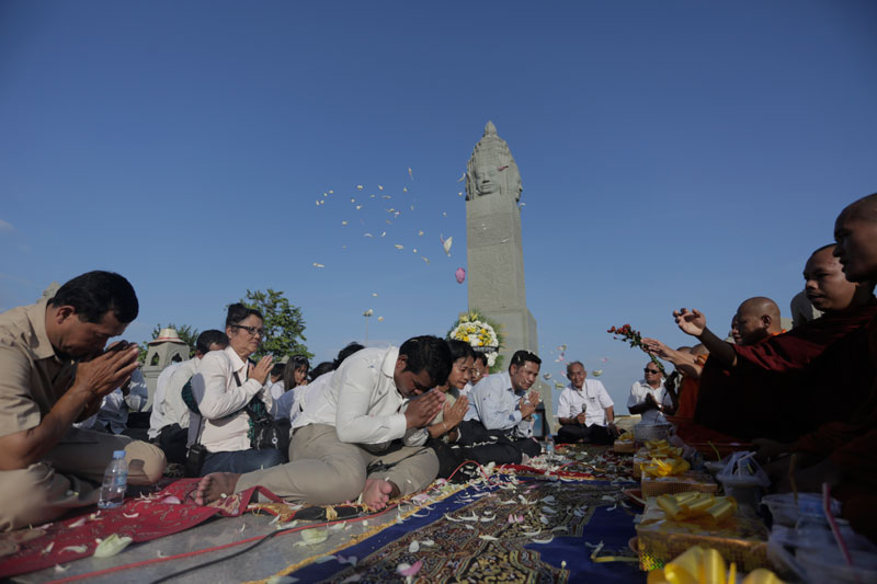 Attendees at a CNRP-organized event to mark the anniversary of the 2010 Water Festival stampede receive blessings from monks at the Koh Pich memorial stupa on Friday. (Siv Channa/The Cambodia Daily)