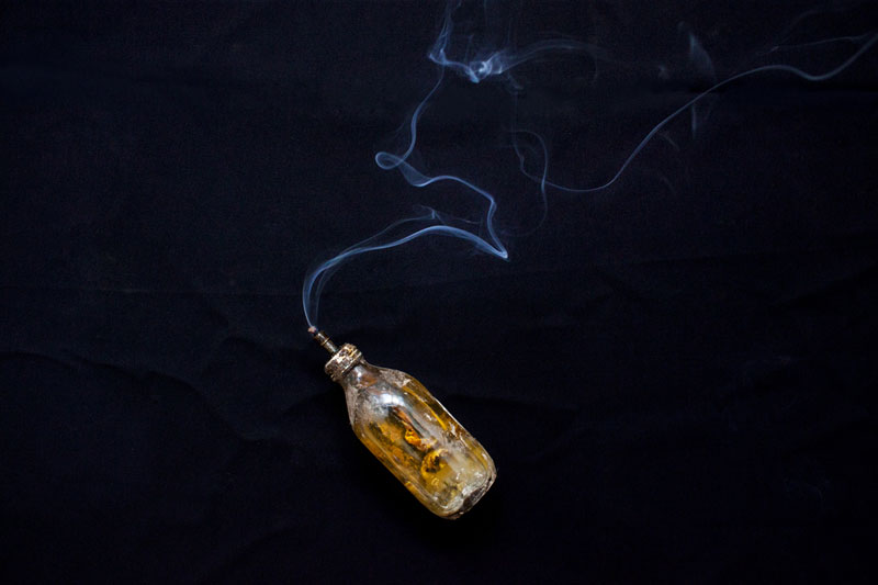 ‘Fish Oil and Smoke’ by Kim Hak. The bottle, once owned by Gnet Yorn, was used to provide light, as there was no electricity in the countryside under the Khmer Rouge. (Kim Hak)