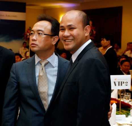 Royal Group chairman Kith Meng, left, and Prime Minister Hun Sen's youngest son, Hun Many, are seen at a signing ceremony Tuesday night to set up Cambodia Airlines, a joint venture between Mr. Meng's Royal Group and the San Miguel Corporation, the company that controls Philippine Airways. (Siv Channa)