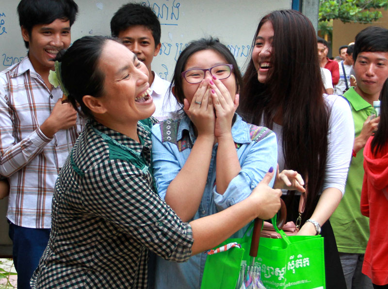 A student reacts with joy after her pass result was read out at Bak Touk High School on Friday. (Siv Channa/The Cambodia Daily)