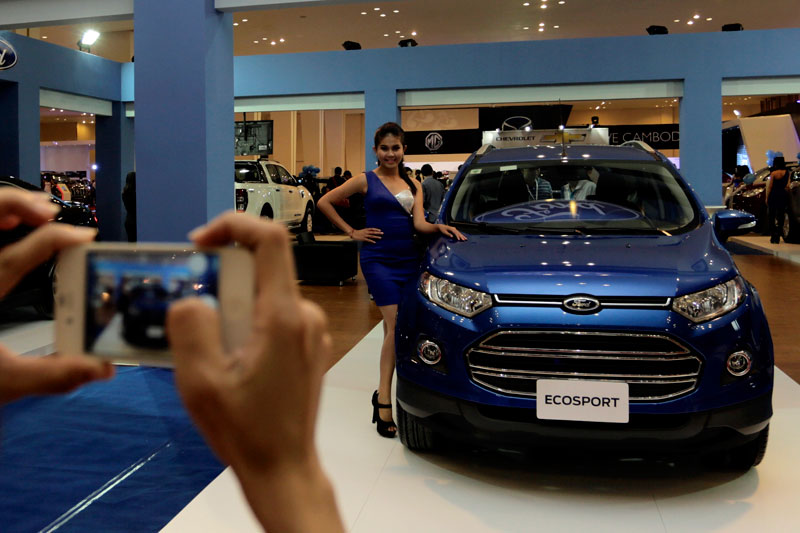 A model poses next to a car at the CamAuto Show on Phnom Penh's Koh Pich island on Thursday. (Siv Channa/The Cambodia Daily)