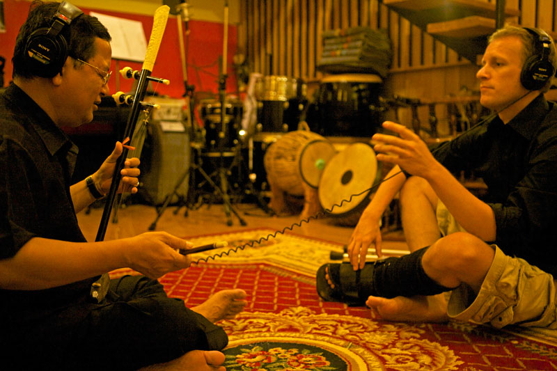 Traditional musician Yun Theara plays during a recording session with Norwegian composer Ingolv Haaland. (Jonas Bostrom)