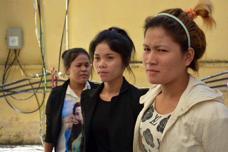From right to left: shooting victims Nuth Sakhorn, 25; Bun Chenda, 24; and Keo Nea, 22, stand outside the Supreme Court on Friday during a break in proceedings. (Alex Consiglio/The Cambodia Daily)